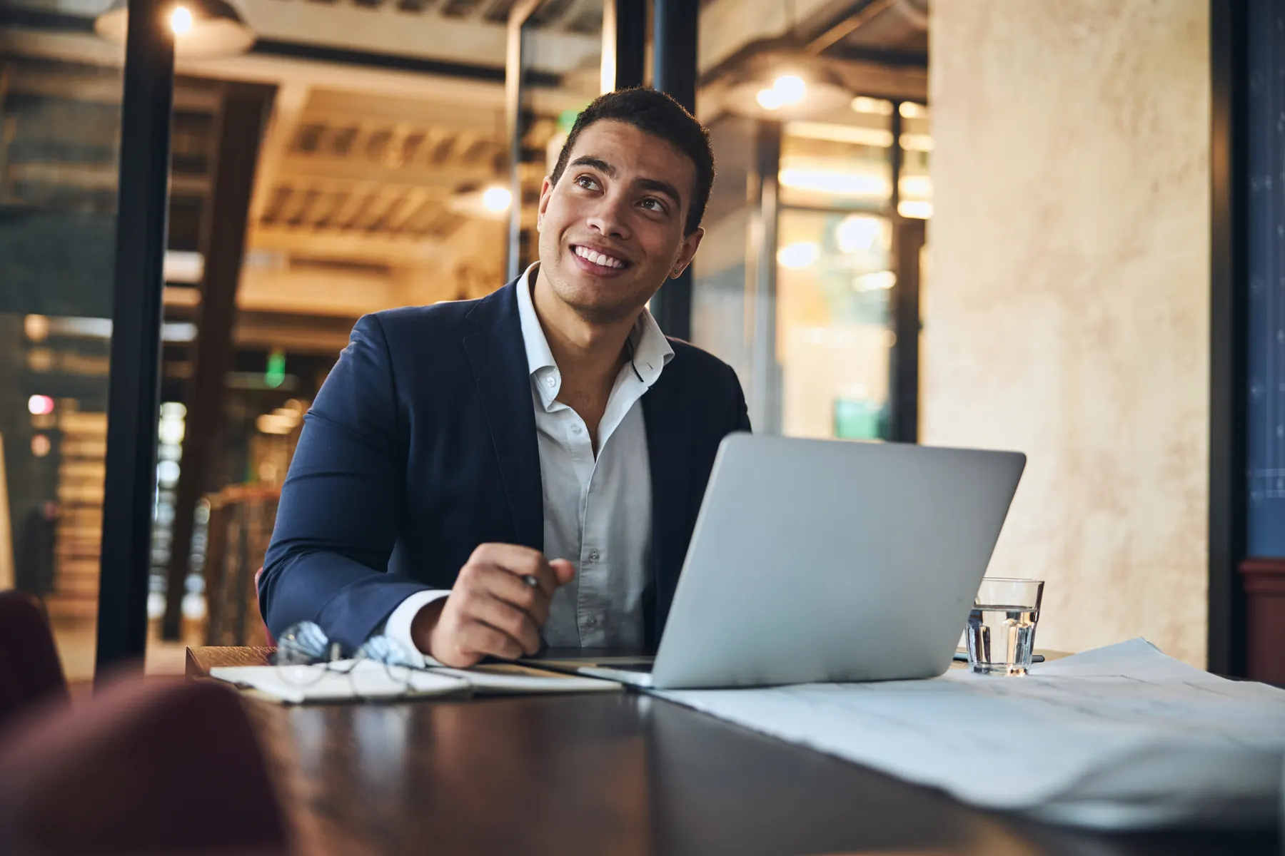 Executive working at a table with a laptop