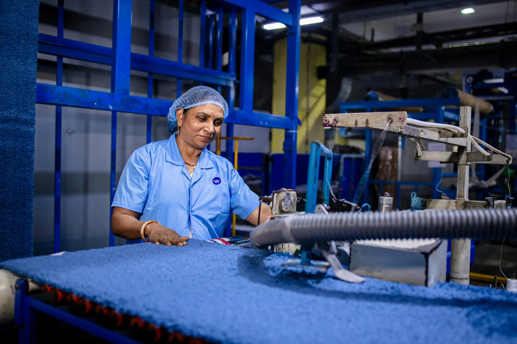 Technician working beside food production equipment